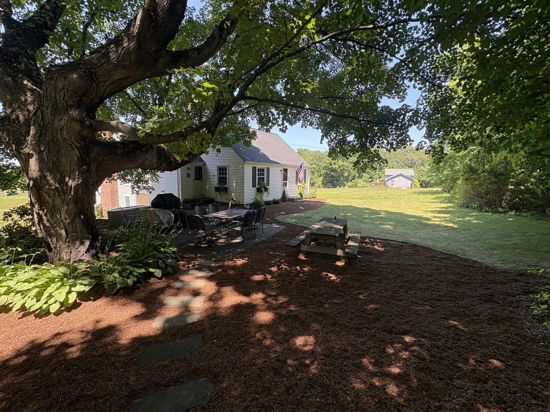 Paver walkway leading through a landscaped front yard